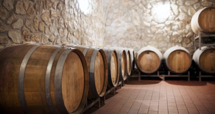 Barrels in cellar, wine making concept. Copy space